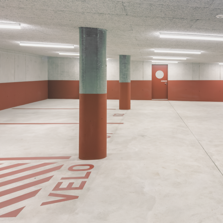 Schmid Ziörjen Architektenkollektiv, Binningen, red, parking, graphic, concrete, light